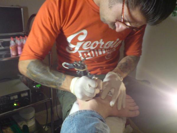 Dee's first tattoo - a star on Chris's ankle